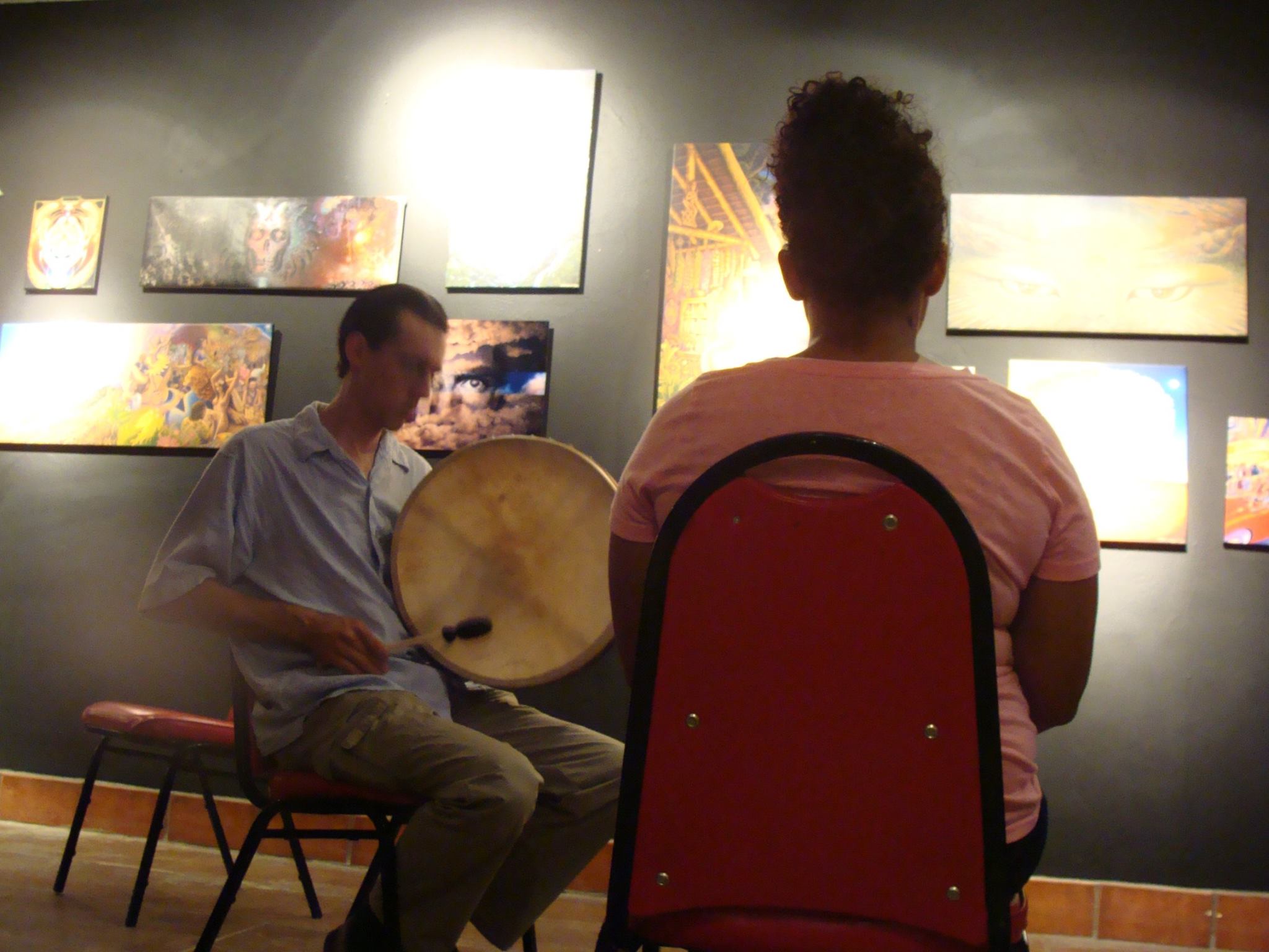 463951436 8515633601817686 531450108613230968 n Sitting in chairs, playing a drum, with a client who is meditating.